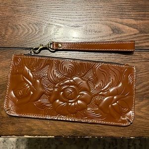 Wristlet/wallet. Tooled leather. Never used. 6card slots & 1 inside divider.